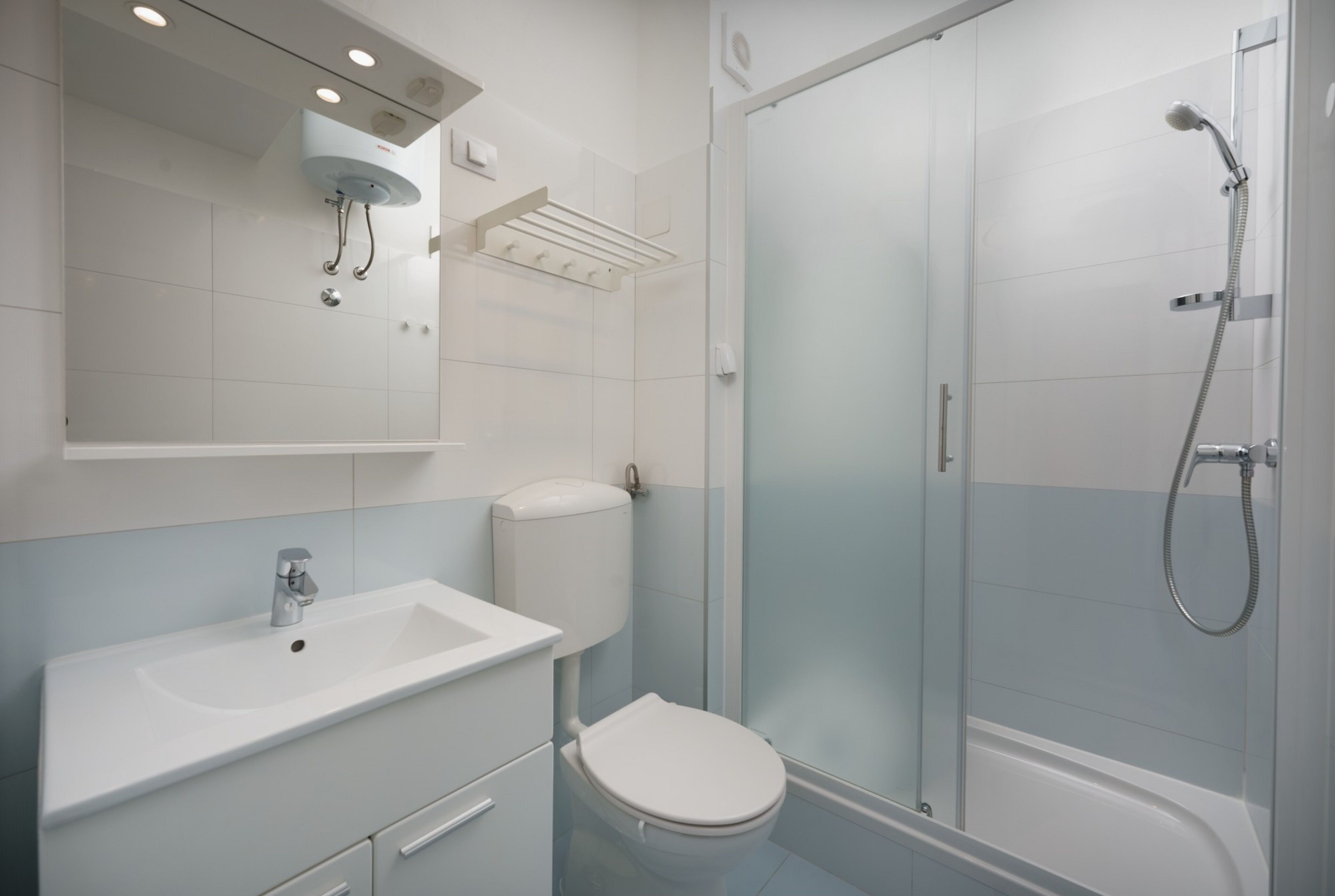 Standard Apartment, Garden View | Bathroom | Shower, hair dryer, slippers, towels