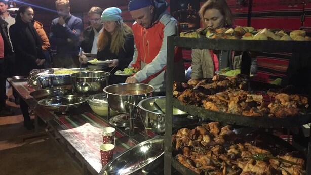 A buffet setup with various food items and serving utensils. - Rum Road - Hostel (Wadi Rum)