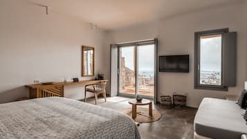 Une chambre moderne avec un grand lit, un bureau et une télévision.