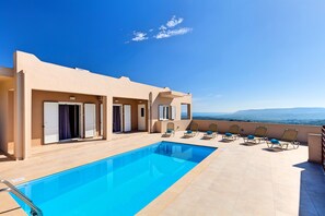 A rooftop pool area with a clear view of the mountains, a pool, and several sun loungers. - Villa di Giorgio Heated Pool (Apokoronas)