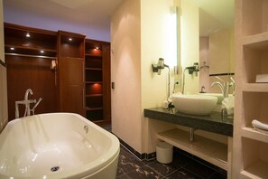 A modern bathroom with a freestanding bathtub, a large mirror, and built-in shelves. - Zum Roten Bären (Freiburg im Breisgau)