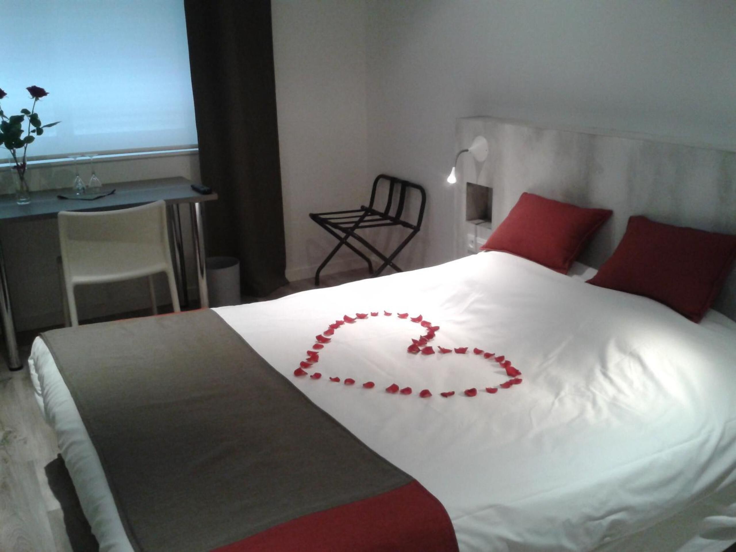 Une chambre d’hôtel avec un lit, un bureau et une chaise.