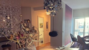 A modern dining area with a glass table, candles, and a decorative plant. - Mortens Kro Boutique Hotel (Aalborg)