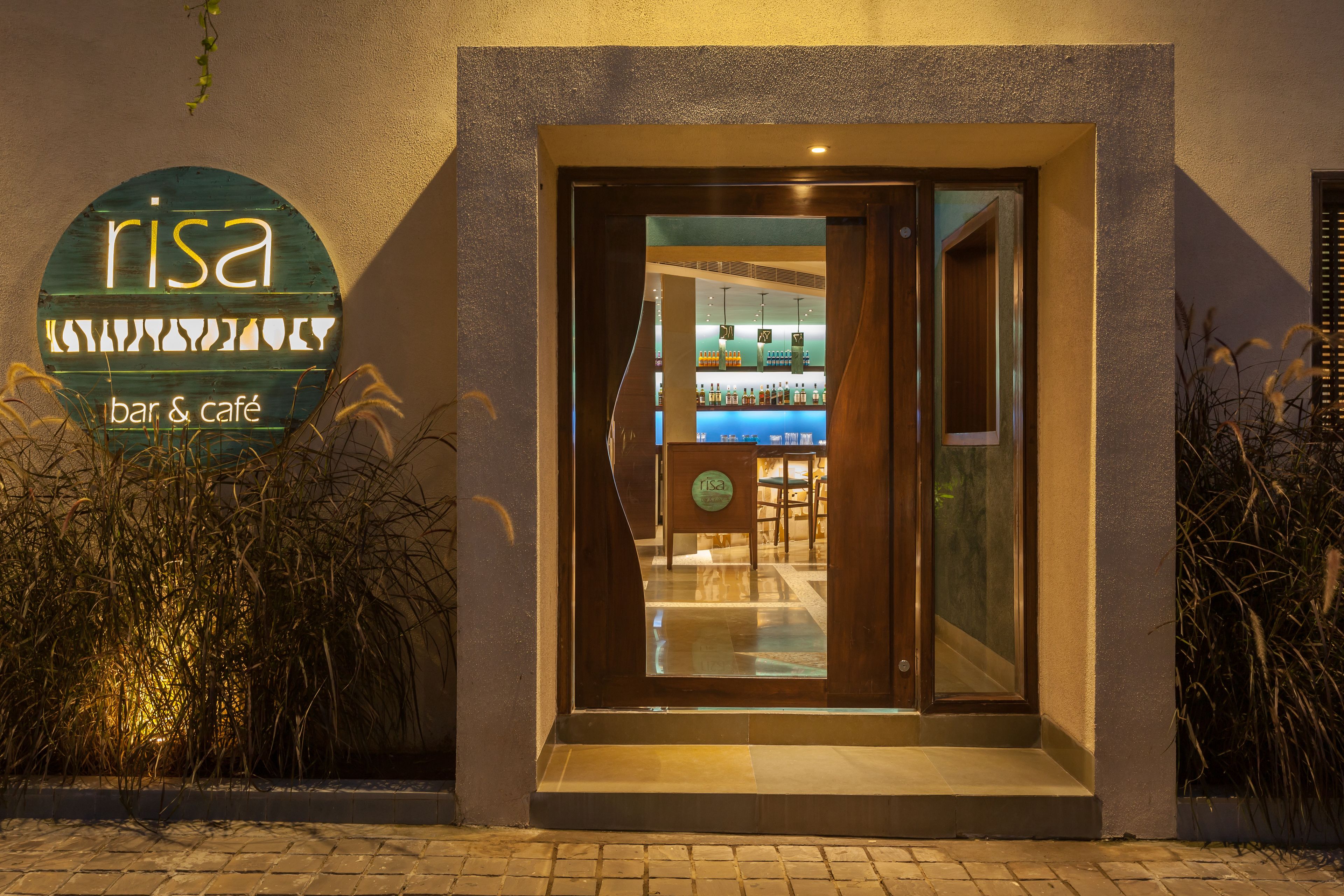 A bar and café named 'Risa' with a modern entrance and visible interior seating.