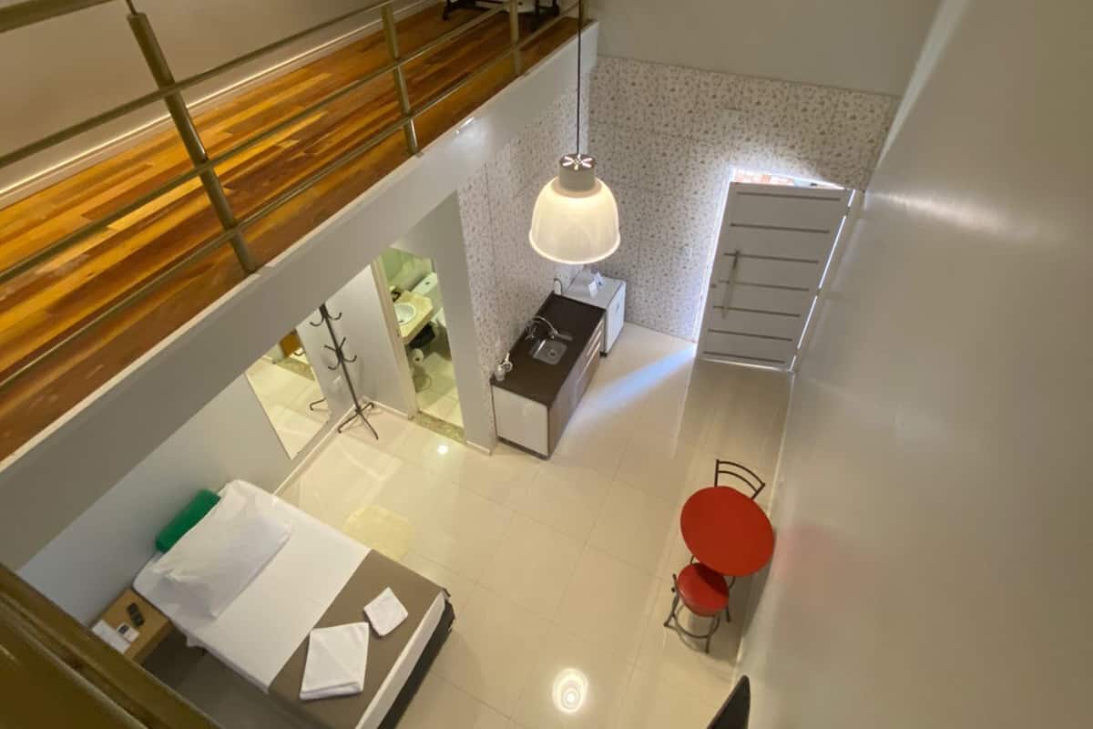 A modern interior with a kitchen, dining area, and a staircase.