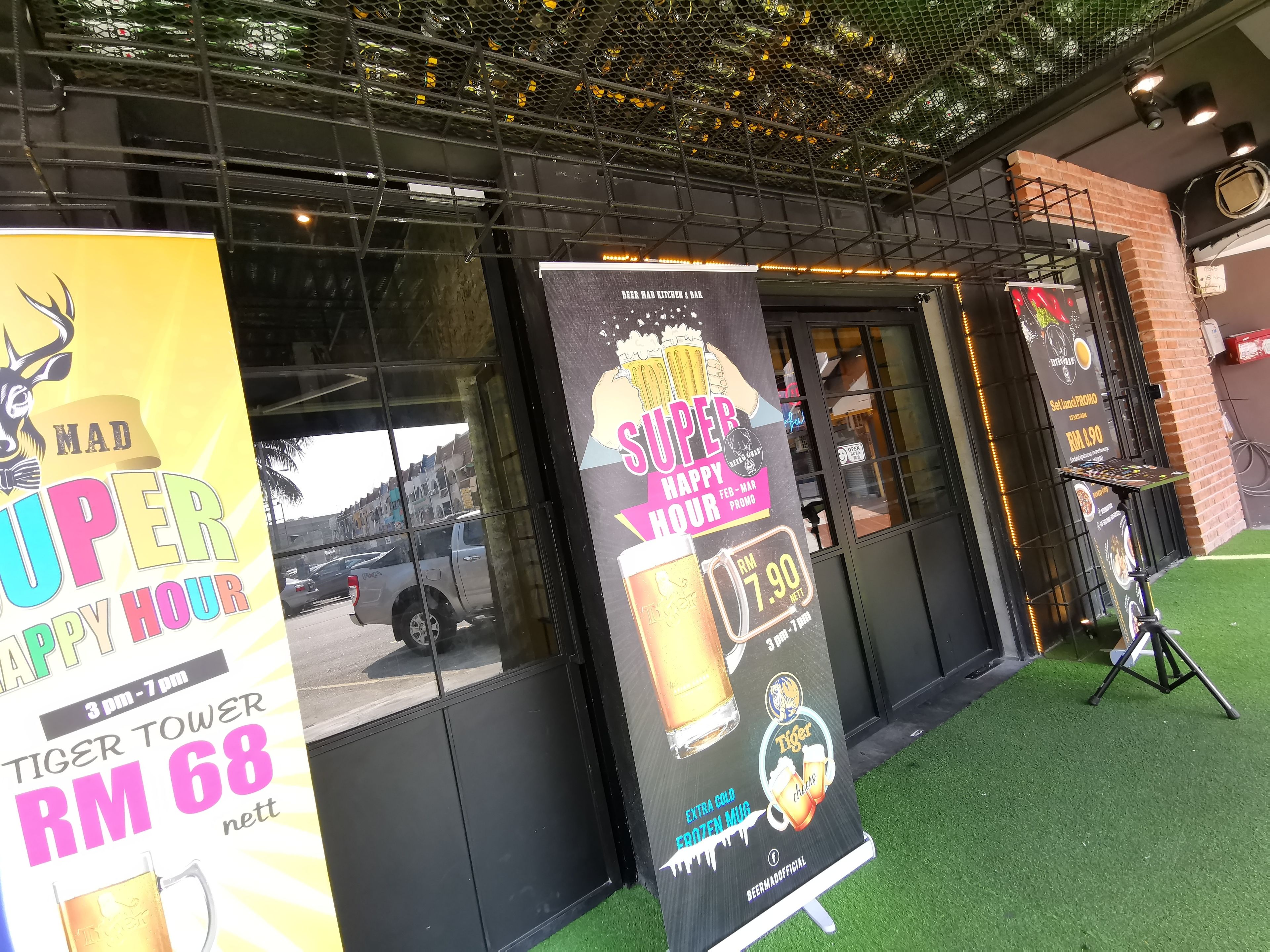 A restaurant with a tiger tower drink promotion and a happy hour offer.