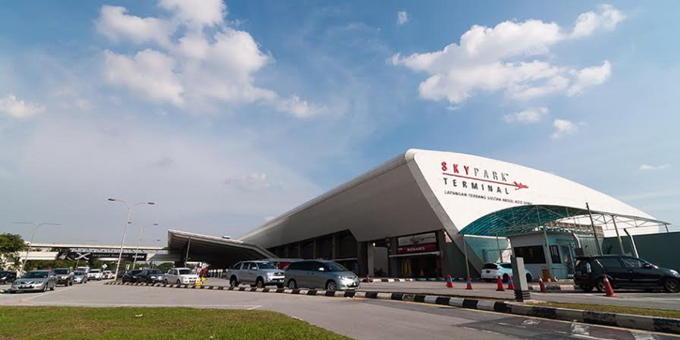 A modern airport terminal with a prominent 'SKY PARK Terminal' sign.