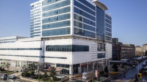 A multi-story hotel with a modern glass facade, a prominent sign at the top, and a ground-level entrance. - Gaziantep Plaza Hotel (Gaziantep)