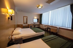 A hotel room with two beds, a desk, a chair, a mirror, and a window with curtains. - Gaziantep Plaza Hotel (Gaziantep)