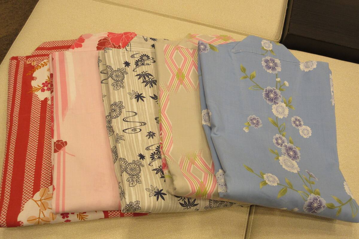 A set of folded fabrics with various patterns and colors.