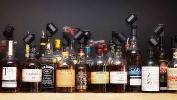 A variety of liquor bottles arranged on a shelf.