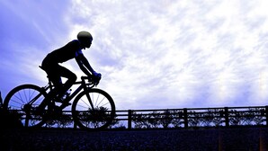 A silhouette of a person riding a bicycle against a sky with clouds. - Ryokan OGI Onsen Ryokan Kamomeso Sadog (Sado)