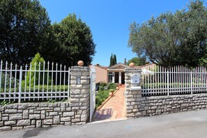 Enter a, gated community with a beautifully maintained garden and traditional architecture.