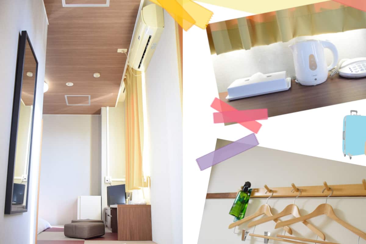 A hotel room with a wooden ceiling, a flat-screen TV, a bedside table, and a bed.