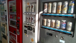 Vending machines with various beverages and snacks, including Coca-Cola and Sapporo beer. - OTA Daiichi Hotel (Ota)