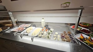 A buffet with various food items and condiments. - Panorama B&B (Ptuj)