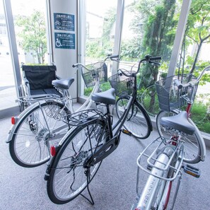 Bicycles parked inside a building with large windows. - Castle Inn Sendai (Sendai)