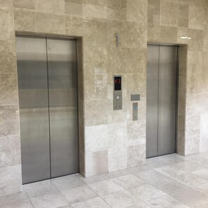 Two elevator doors with a digital display above them. - Castle Inn Sendai (Sendai)