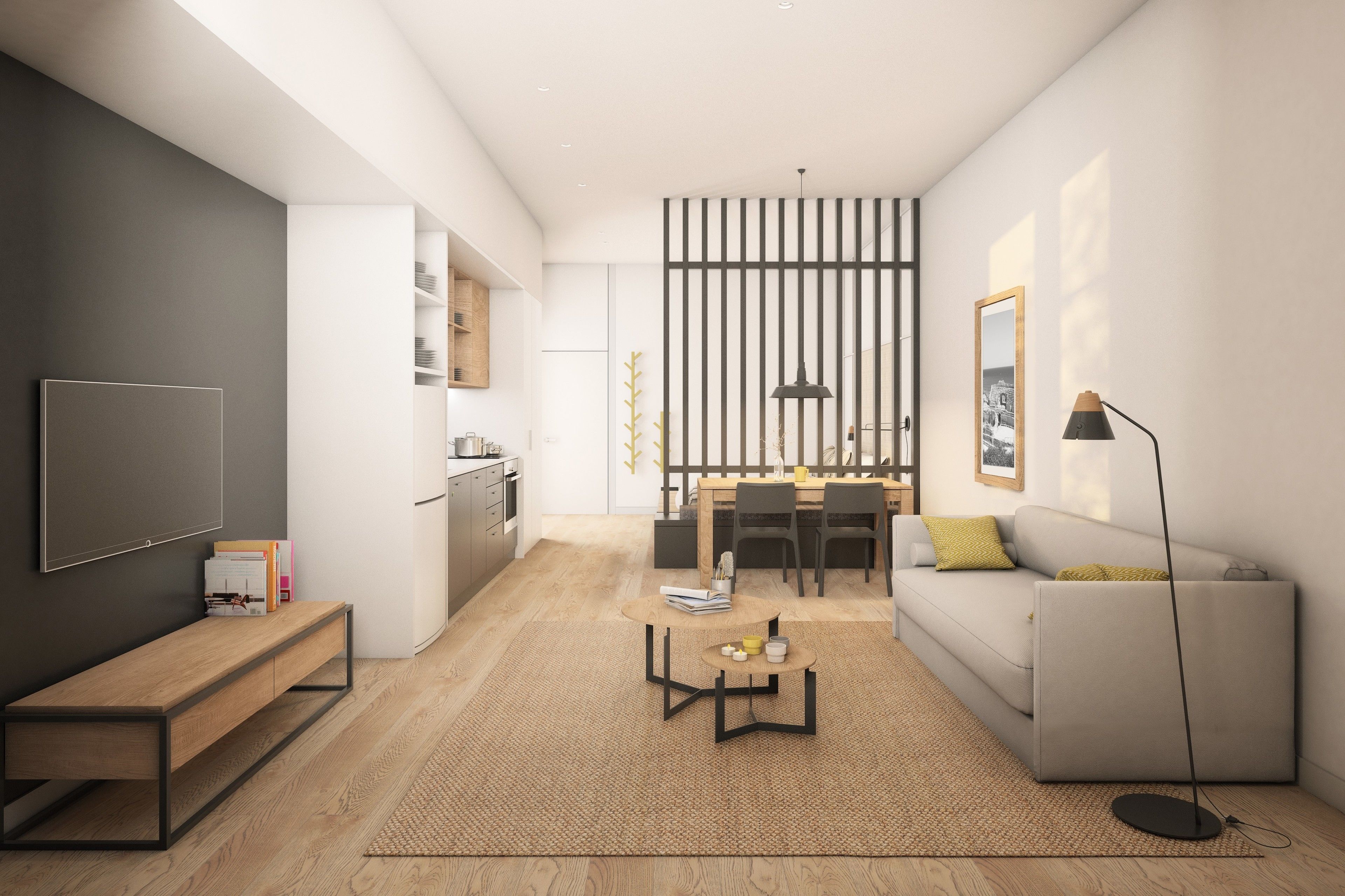 Una sala moderna con sofá, mesa de centro y televisor. Hay una zona de cocina con mesa y sillas.