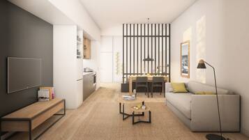 A modern living room with a sofa, coffee table, and a TV. There is a kitchen area with a dining table and chairs.