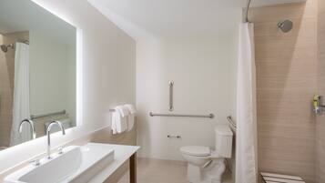 A modern bathroom with a sink, toilet, and shower.