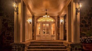 Stunning entrance with a grand, symmetrical design featuring a central doorway and ornate chandelier.