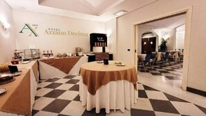 A hotel lobby with a checkered floor, a round table with a brown tablecloth, and a reception desk with a black sign. - Hotel Azzano Decimo (Azzano Decimo)