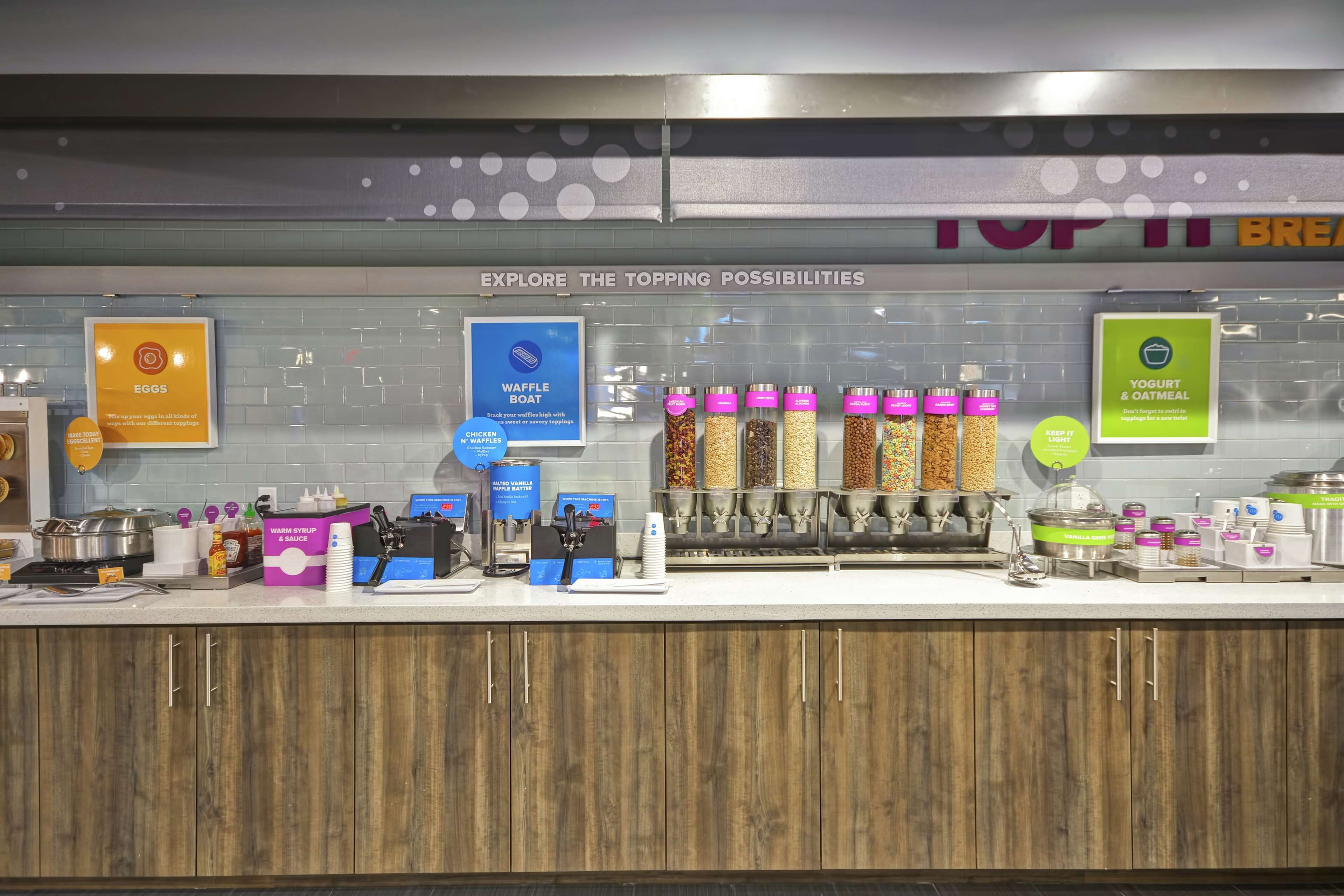 A breakfast bar with various food options and condiments.