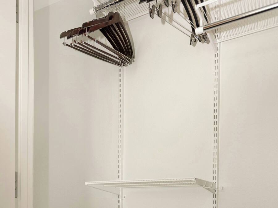 A storage closet with shelves and baskets.