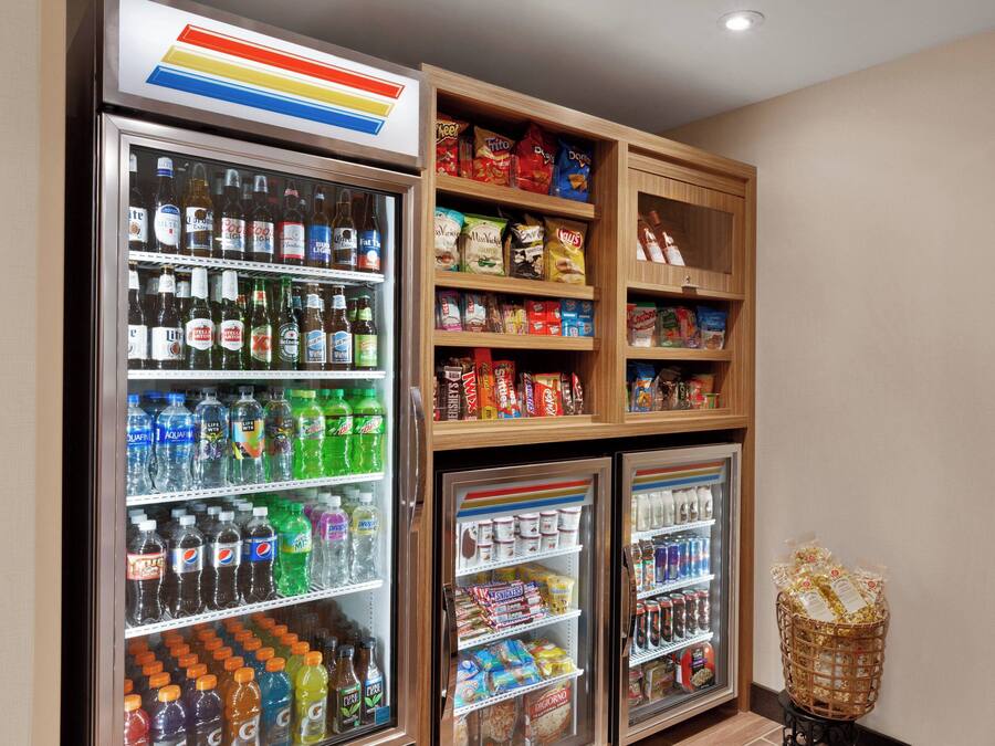 A vending machine area with various beverages and snacks.
