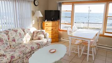 Apartment, 1 Queen Bed, Oceanfront | Living room | Flat-screen TV