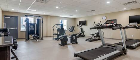 A gym with treadmills, stationary bikes, and weight machines.