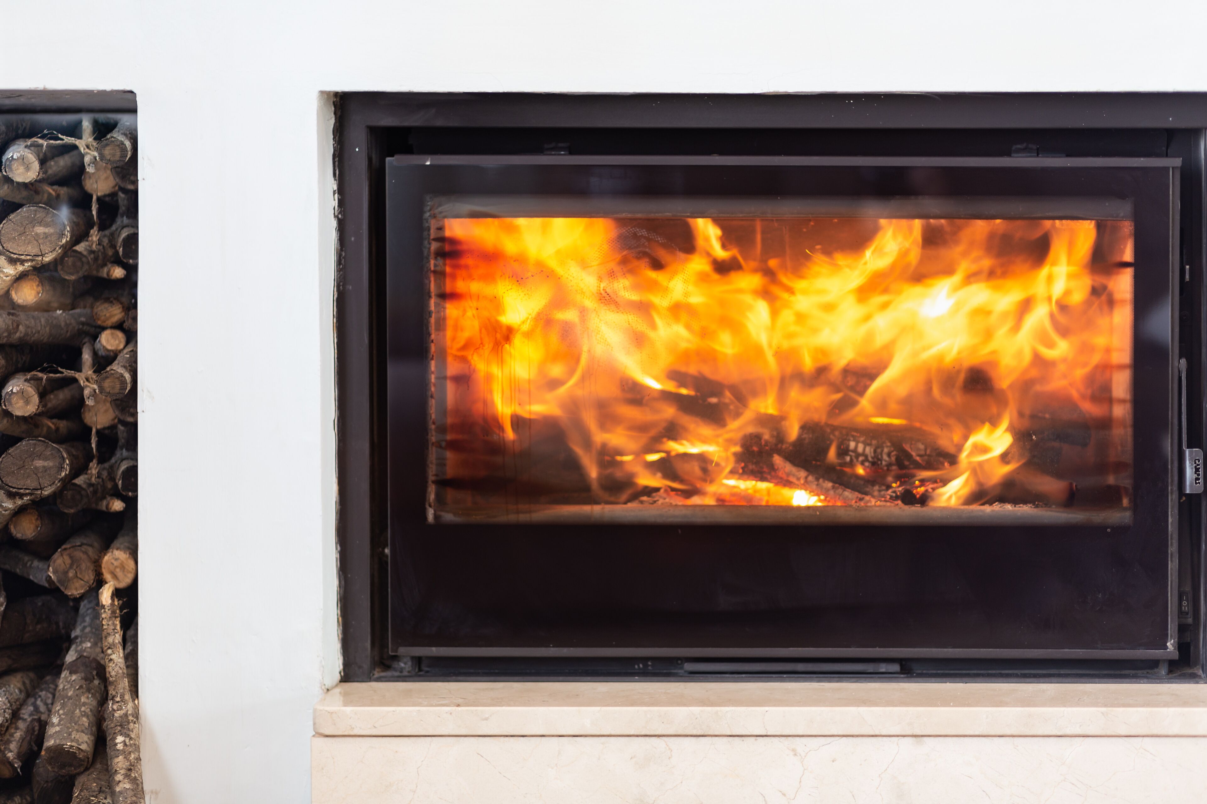 A fireplace with visible logs and flames.