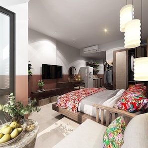 Une chambre moderne comprenant un lit, des tables de chevet, un miroir, une armoire et une petite kitchenette.