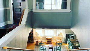A staircase leading to a living area with a view of the outside through a window. - Northside School B&B (Bonners Ferry)