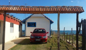 Guests can park their car under the sheltered pergola, with a short walk to the entrance.