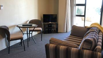 Apartemen Basic, 1 Tempat Tidur Queen, pemandangan laut sebagian | Area keluarga | Televisi LCD 32-inci dengan saluran TV satelit, TV, dan Netflix