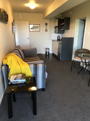 Basic Apartment, 1 Queen Bed, Partial Ocean View | Living area | 32-inch LCD TV with satellite channels, TV, Netflix - Our Beach House - Upper Wainui (Raglan)