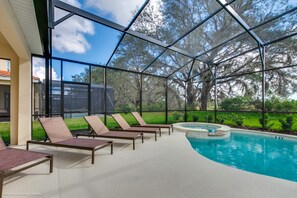 A covered outdoor swimming pool with lounge chairs and a hot tub. - Solterra Exec Villas- 6104boa (Davenport)