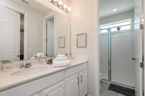 A bathroom with two sinks, a large mirror, and a shower area. - Solara Resort Exec Villas- 9091sr (Kissimmee)