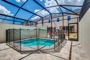 A covered outdoor swimming pool with a clear view of the surrounding buildings. - Solara Resort Exec Villas- 1542cpc (Kissimmee)