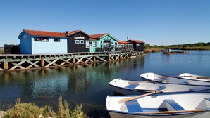 A waterfront property with a restaurant, a café, and a blue building with a red roof.
