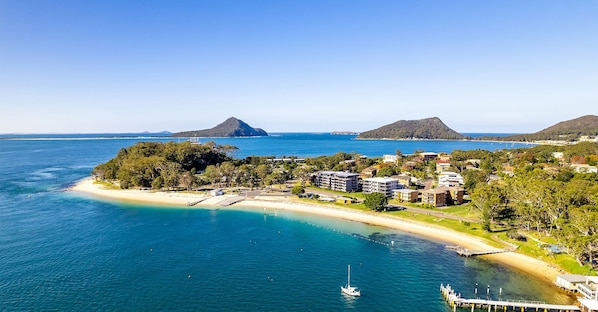 Enjoy the serene beachfront setting with access to the marina and lush surroundings.