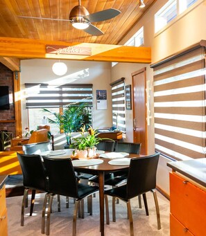 A dining area with a wooden ceiling, a ceiling fan, and a sign that reads "gather." - Hilltop Hideaway, cozy forest retreat, Portland (Portland)