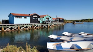 A waterfront property with a restaurant, a café, and a blue building with a red roof.