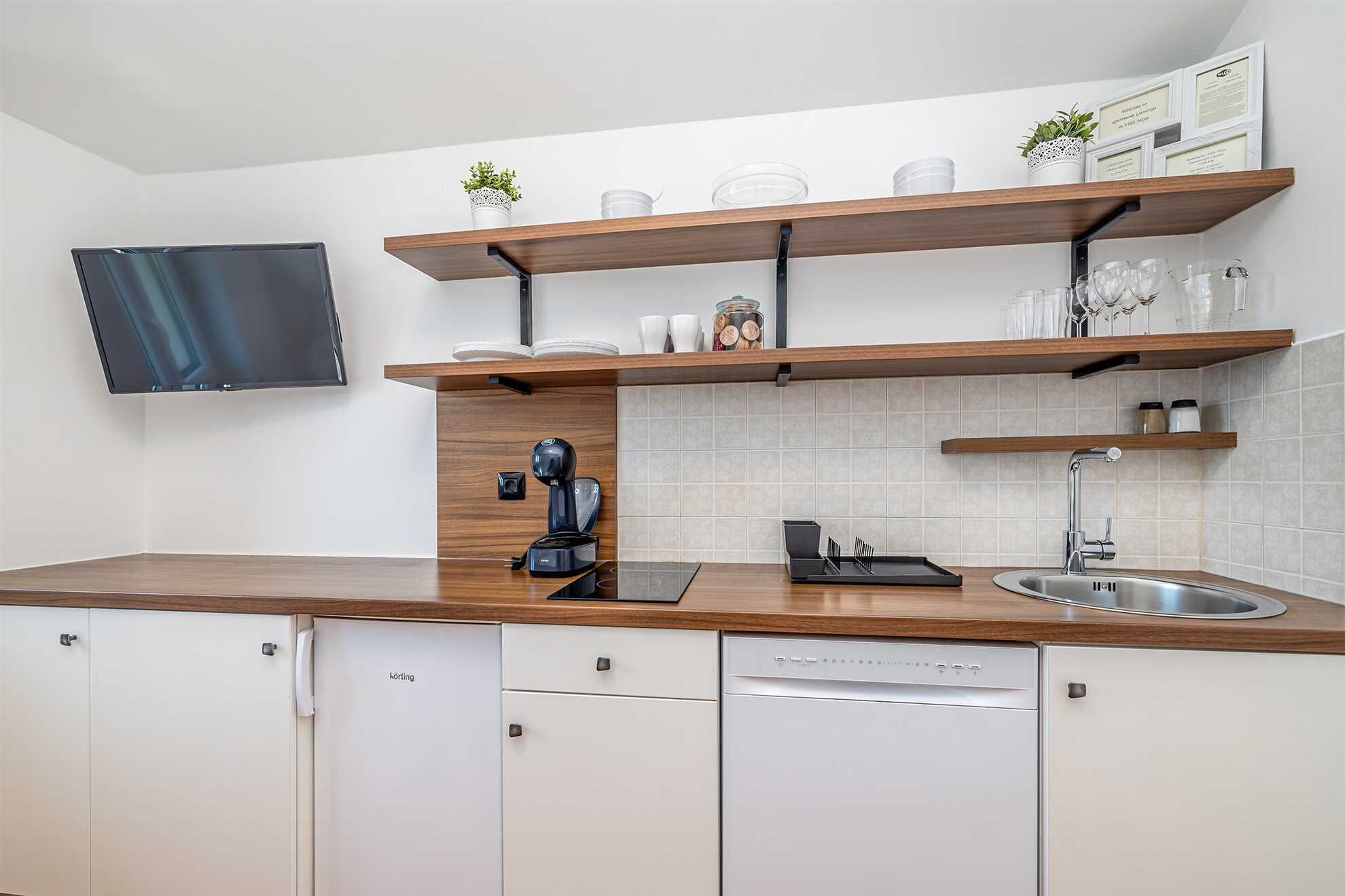 Fridge, stovetop, dishwasher, coffee/tea maker