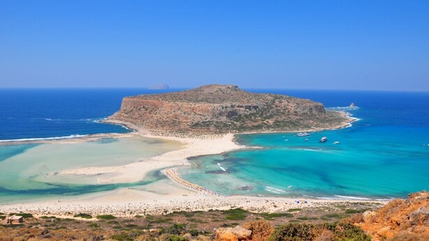 A coastal landscape with a rocky island, clear turquoise waters, and a sandy beach. - Steps from the beach, Near city centre,Angela apartment (Chania)