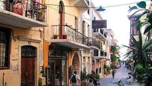A narrow street lined with buildings, some with balconies and potted plants. - Steps from the beach, Near city centre,Angela apartment (Chania)