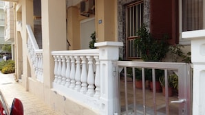 A building with a beige facade, a white balcony railing, and a number '56' sign. - Steps from the beach, Near city centre,Angela apartment (Chania)