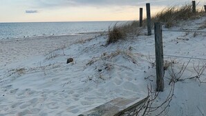 A sandy beach with wooden posts and a wooden boardwalk. - West Dennis Central - 5 bed, 3 bath, 2 kitchen huge yard!
Two hot tubs! (Dennis)
